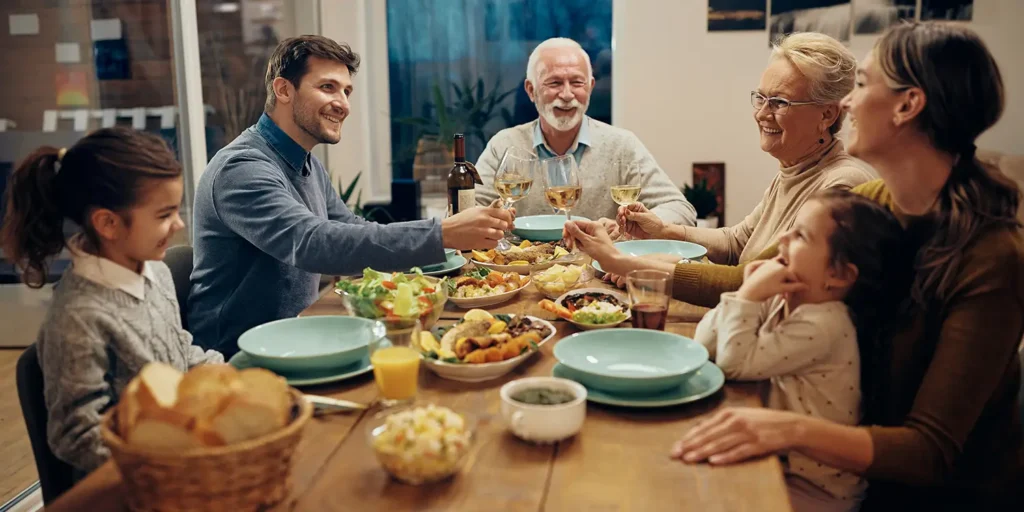Generational family toasting over dinner. Notes Regarding Intergenerational Sharing of Homes