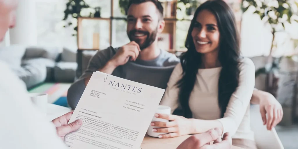 A happy couple meeting with conveyancer - A Buyer’s Guide to Conveyancing