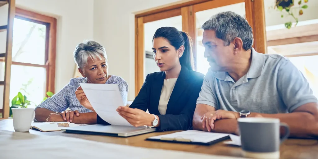 Wills & Probate: Why Do I Need A Will? Image of older couple discussing a will with a solicitor