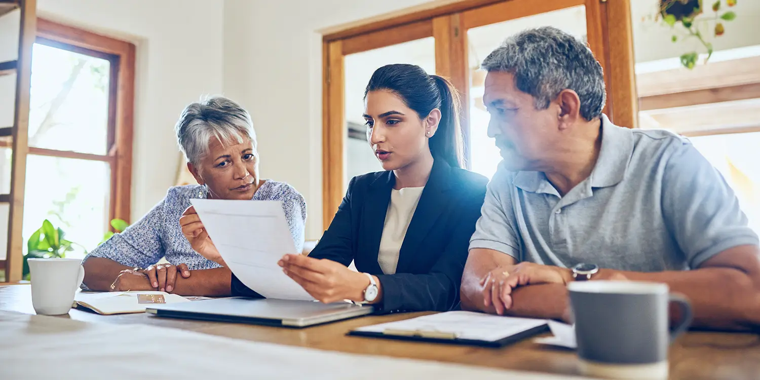 Wills & Probate: Why Do I Need A Will? Image of older couple discussing a will with a solicitor