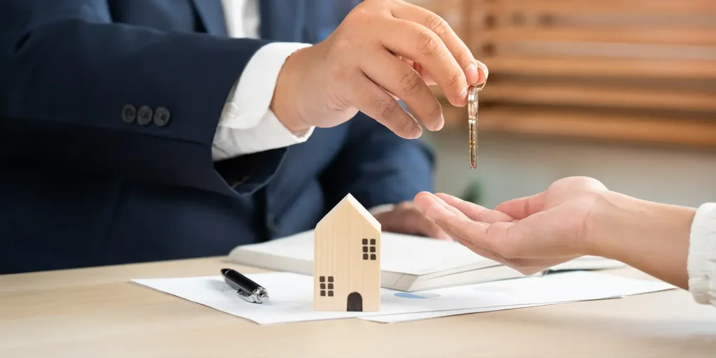 Landlord handing over new house keys - Essential Landlord Rules on Holding and Security Deposits