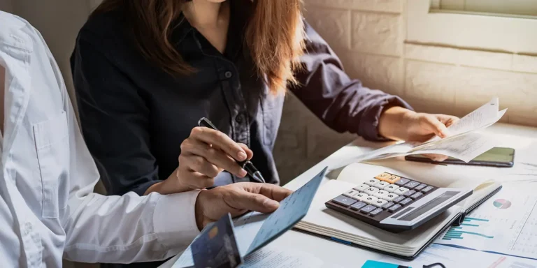 Concerned businesswoman reviewing finances during debt collection process