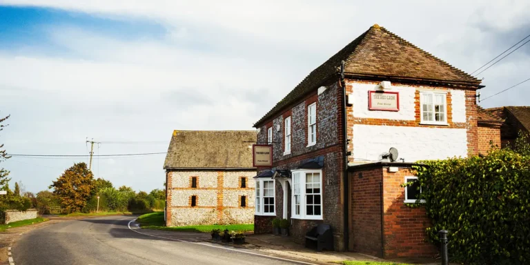 Traditional English village pub building on a country road, representing an Asset of Community Value – image for Nantes Solicitors Dorset property law article