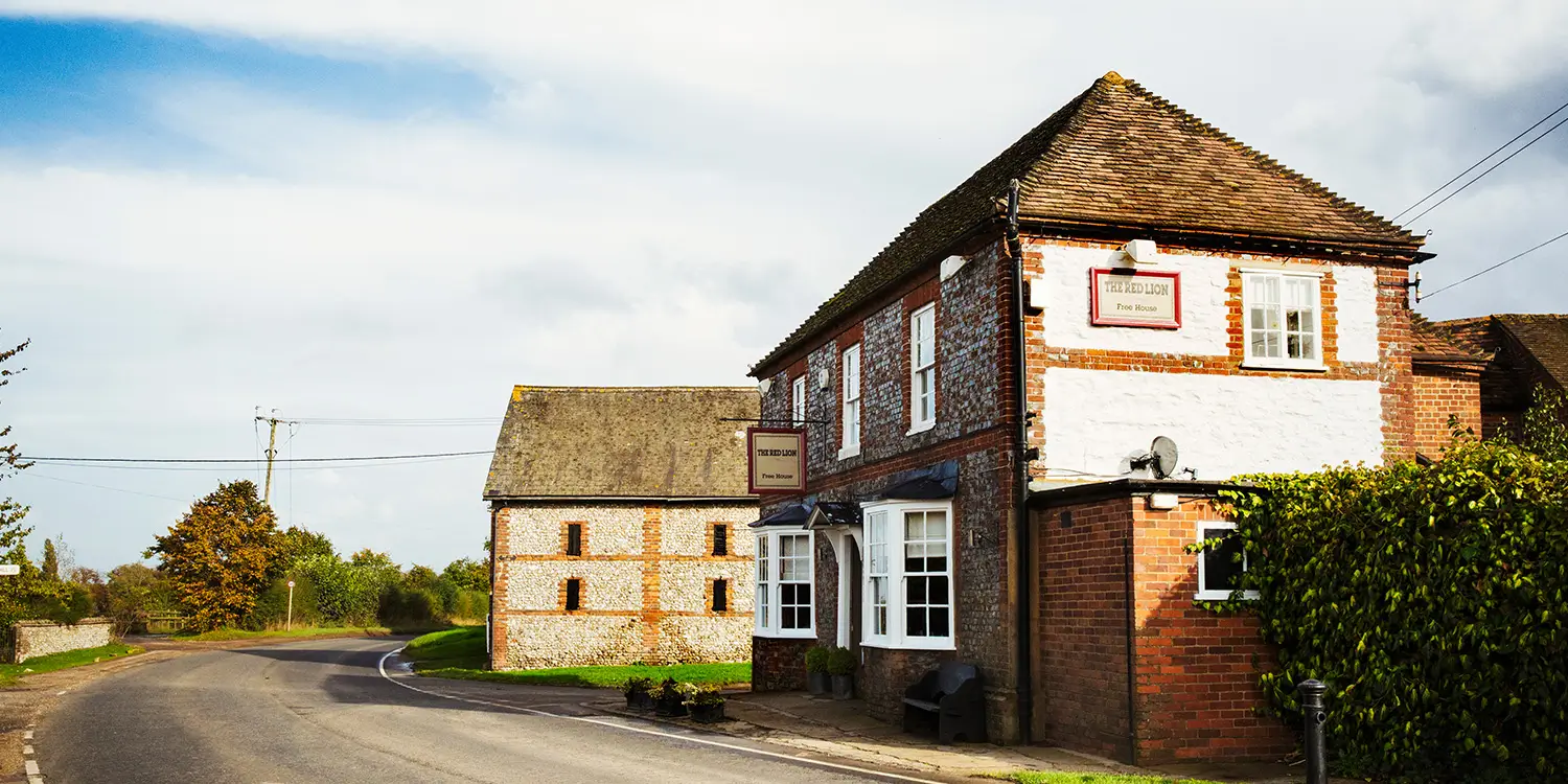 Traditional English village pub building on a country road, representing an Asset of Community Value – image for Nantes Solicitors Dorset property law article