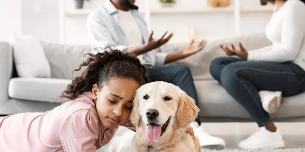 Child with family dog during parents’ divorce discussion – illustrating pet disputes in divorce, Nantes Solicitors Dorset